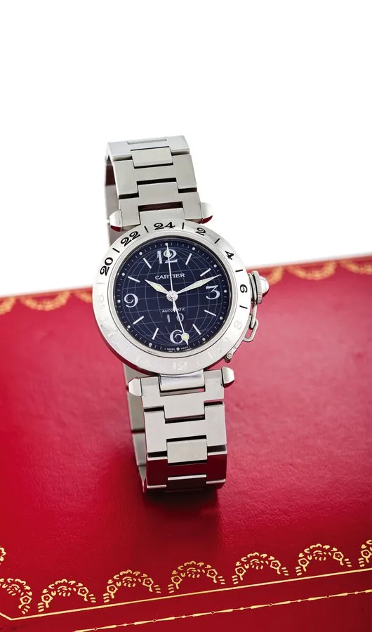 CARTIER PASHA GMT STEEL Cartier, "Pasha GMT," case No. 301068PB, Ref. 2377. Made circa 2000. Fine, center-seconds, self-winding, water-resistant, two time zone, stainless steel wristwatch with date and a stainless steel Cartier link bracelet with double deployant clasp. Accompanied by a fitted box