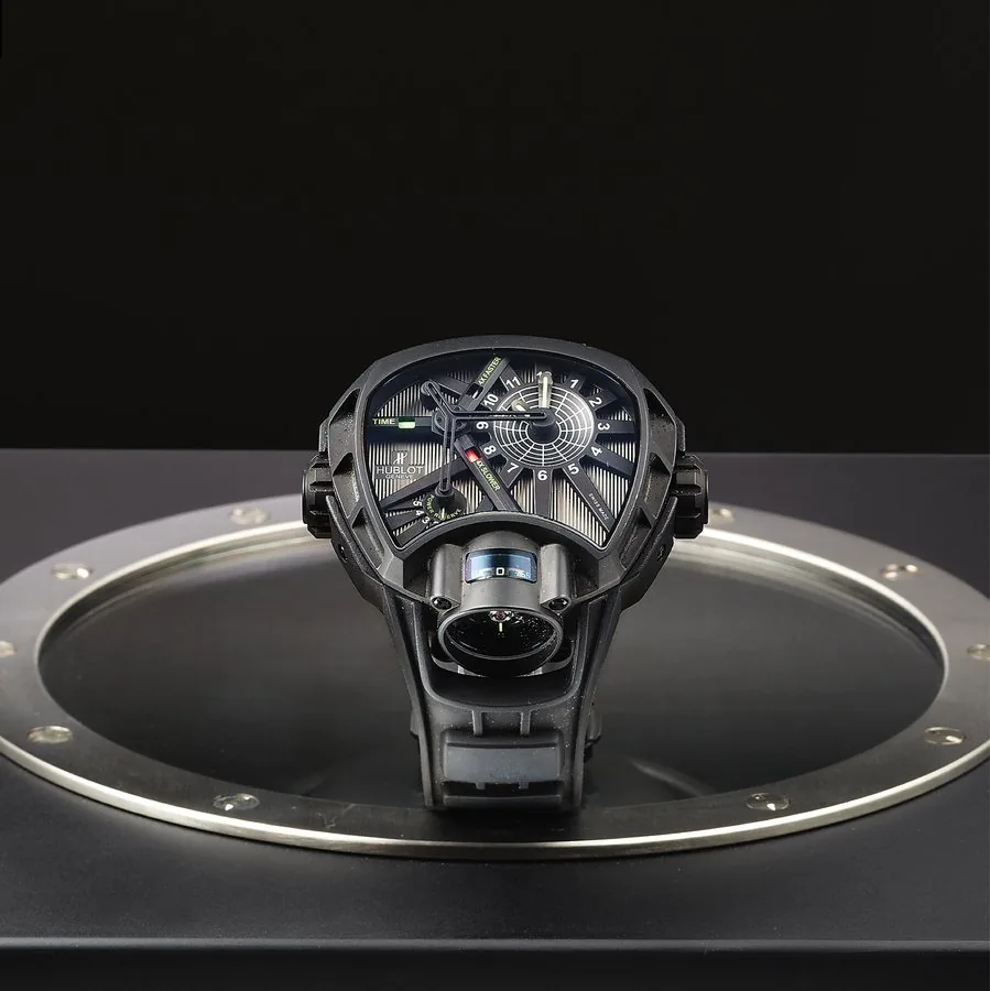 HUBLOT REF. MP-02 FLYING TOURBILLON TITANIUM PVD COATED Hublot, Genève, "MP-02 Tourbillon" No. 08/50, case No. 910613, Ref. MP-02. Made in a limited edition of 50 pieces circa 2010. Very fine, rare and unusual, water-resistant, ceramic, titanium PVD-coated wristwatch with visible one-minute flying tourbillon regulator viewable in the band at 6, time speed indicator, power reserve indicator and a special integrated rubber strap with a titanium PVD-coated Hublot deployant clasp. Accompanied by the