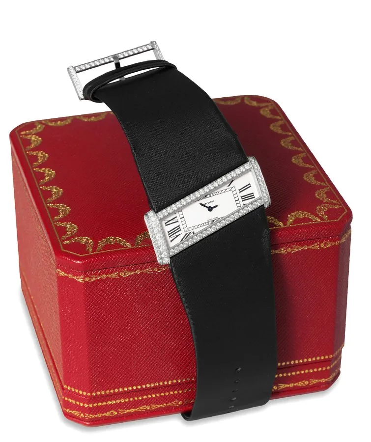 Cartier White Gold and Diamonds Cartier, No. 2786, Ref. 20813CE. Sold on December 24, 1999. Very fine and extremely elegant, quartz, inclined rectangular, 18K white gold and diamond-set lady's wristwatch with Cartier satin bracelet and an 18K white gold and diamond-set large buckle, set with a total of 136 white diamonds. Accompanied by the original Cartier box and guarantee.