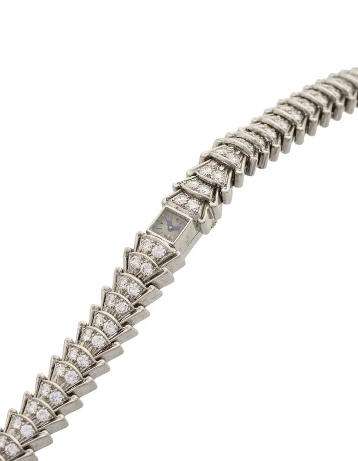 JAEGER LECOULTRE, CAL. 101, PLATINUM AND DIAMONDS Jaeger-LeCoultre, case No. 552455. Made circa 1935. Fine and elegant, platinum and diamond lady's wristwatch with back winding and articulated integral platinum bracelet, all links and clasp set with a double row of round diamonds. Accompanied by the Jaeger Lecoultre extract from the archives