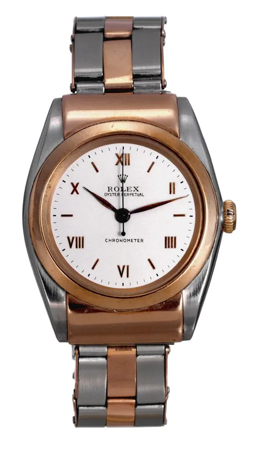 Ref. 3065, "Rigid Hooded" Rolex, 'Oyster Perpetual, Chronometer', case No. 413382, Ref. 3065. Made in 1945. Very fine and rare, tonneau-shaped, self-winding, center seconds, water-resistant, stainless steel and pink gold wristwatch with a stainless steel and pink gold expanding riveted Rolex bracelet with deployant clasp.