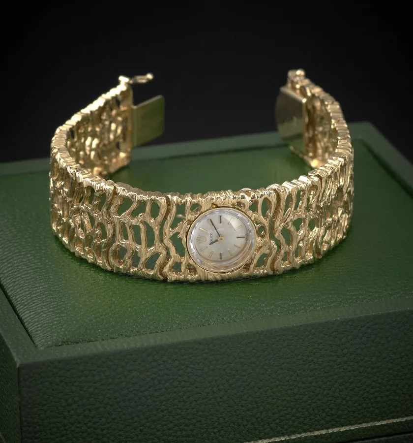 ROLEX LADY'S YELLOW GOLD Rolex, case No. 90320. Made in the 1960s. Fine, 14K yellow gold lady's wristwatch with an integral 14K yellow gold textured & pierced bracelet. Accompanied by a fitted box. To be sold without reserve