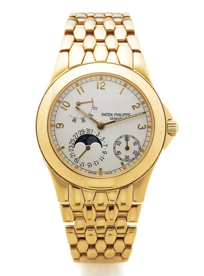 PATEK PHILIPPE REF. 5085 YELLOW GOLD Patek Philippe, Genève, movement No. 3112075, Ref. 5085/1 J. Made in 2000. Very fine and rare, self-winding, water-resistant, 18K yellow gold wristwatch with date, phases of the moon, 48-hour power reserve indication and an 18K yellow gold integral link bracelet with concealed double deployant clasp.