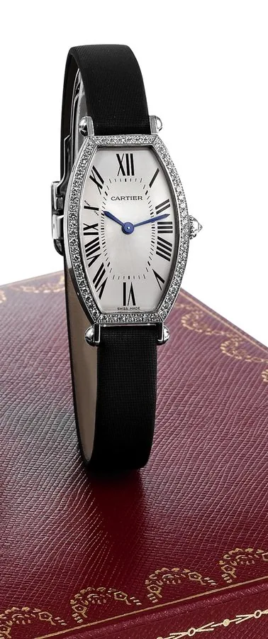 CARTIER TONNEAU CINTREE WHITE GOLD AND DIAMOND Cartier, Paris, Tonneau Cintrée, No. 21753NX, Ref. 2711. Made circa 2000. Fine and elegant, tonneau-shaped, curved, 18K white gold and diamond-set lady's wristwatch with an 18K white gold Cartier deployant clasp. Accompanied by a fitted Cartier box, certificate and booklets.