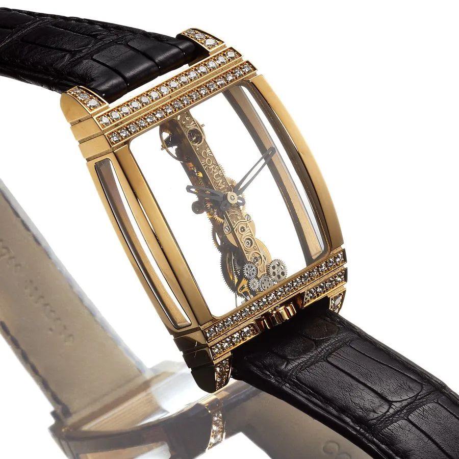 CORUM REF. 113.553 GOLDEN BRIDGE YELLOW GOLD & DIAMOND Corum, Swiss, Ref. 113.553. Made in celebration of CORUM's 50th Anniversary in 2006. Very fine, large, 18K yellow gold and diamonds, curved tonneau-shaped wristwatch with visible Golden Bridge movement and an 18K yellow gold Corum buckle. Accompanied by the Golden Bridge Certificate, Certificate of Authenticity and hang tag.