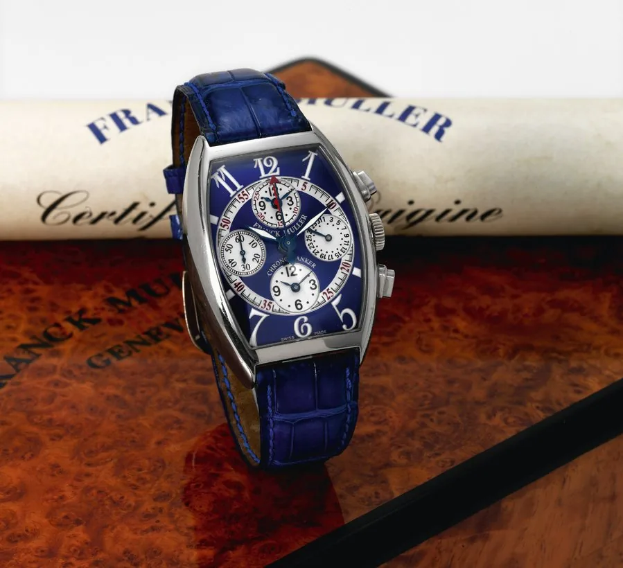 White Gold Chrono Banker Franck Muller, Genève, 'Chrono Banker', No. 180, Ref. 7850 CC MB. Made circa 2000. Fine, tonneau-shaped and curved, self-winding, water-resistant, 18K white gold wristwatch with wedge-shaped button chronograph, instantaneous register, three time zones, date and an 18K white gold Franck Muller buckle. Accompanied by a Franck Muller fitted wooden box, Certificate of Origin and instructions.