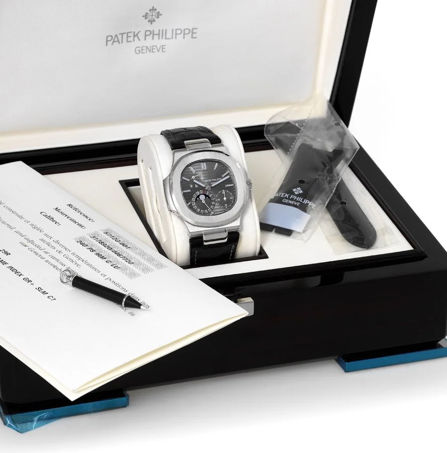 Patek Philippe Ref. 5712G, White Gold Nautilus Patek Philippe, Genève, "Nautilus", movement No. 3178920, case No. 4467720, Ref. 5712G-001. Sold on December 1, 2008. Very fine and rare, large, carré galbé, self-winding, water-resistant 18K white gold wristwatch with date, moon phases, powerreserve indication and an 18K white gold large Nautilus deployant clasp. Accompanied by the Certificate of Origin, setting pin, spare strap and fitted box.