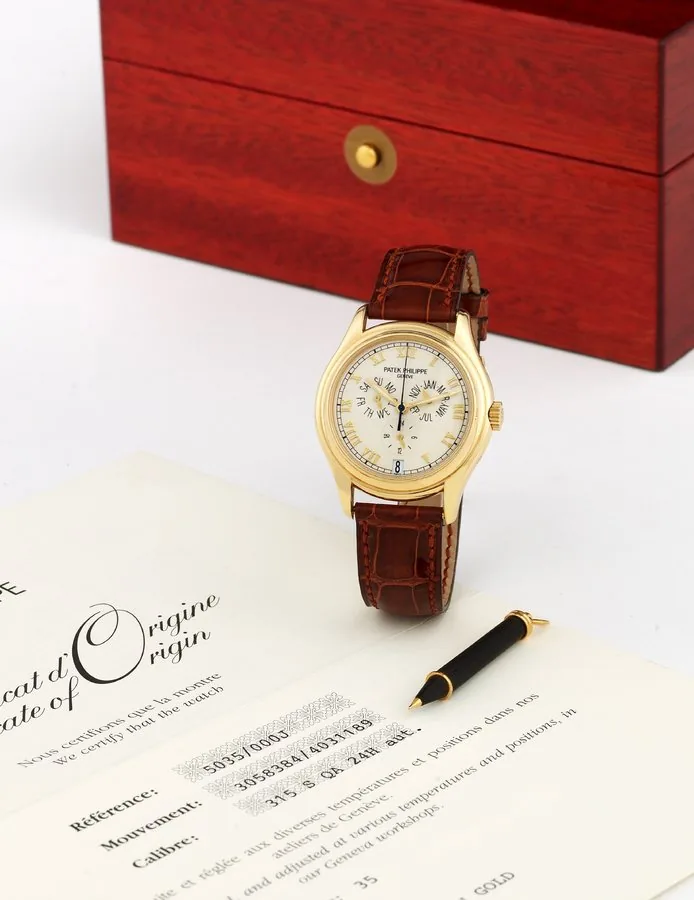 Patek Philippe - Ref. 5035 - Yellow Gold Patek Philippe, Genève, movement No. 3058384, case No. 4031189, Ref. 5035. Production of this reference started in 1996. Made circa 2001. Very fine, center seconds, self-winding, water-resistant, 18K yellow gold wristwatch with annual calendar, 24-hour indication, and an 18K yellow gold Patek Philippe buckle. Accompanied by the original fitted box, certificate of origin and booklet.