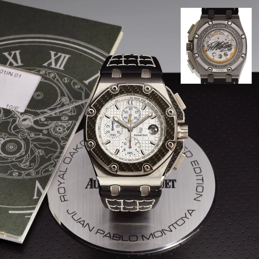 AUDEMARS PIGUET REF. 26042 ROYAL OAK OFFSHORE JUAN PABLO MONTOYA SIGNATURE CASEBACK TITANIUM Audemars Piguet, Genève, Royal Oak Offshore "Juan Pablo Montoya" Chronograph, case No. F 27153, Ref. 26030. Made in a limited edition of 20 pieces in 2004 with Montoya's signature on reverse. Very fine, oversized, octagonal, self-winding, water resistant, titanium, steel and carbon fiber wristwatch with date, square button chronograph, registers, tachometer and an Audemars Piguet stainless steel deployan
