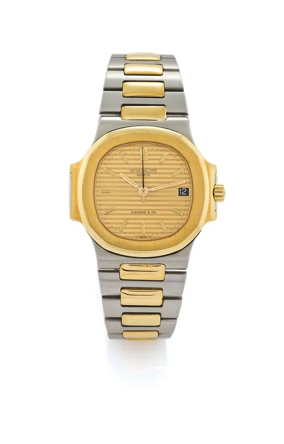 PATEK PHILIPPE REF. 3800/1 NAUTILUS STEEL & GOLD ' FOR TIFFANY & CO Patek Philippe, Geneve, Nautilus, No. 1422114, case No. 2795267, Ref. 3800/001, retailed by Tiffany & Co. Made circa 1985. Fine and very rare, cushion-shaped, center seconds, selfwinding, water-resistant, stainless steel and 18K yellow gold wristwatch with date and a stainless steel and 18K yellow gold Patek Philippe link bracelet with deployant clasp.