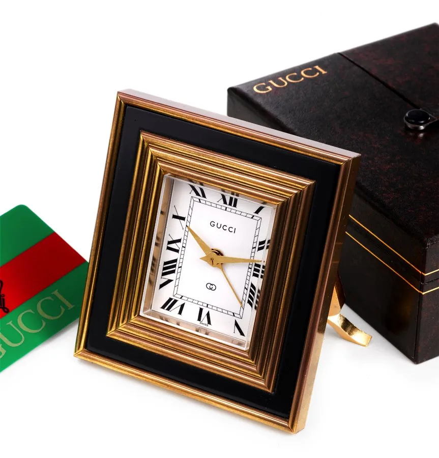 Gucci, Swiss. Made circa 1980. Fine gilt brass, 8 day-going desk alarm clock. Accompanied by the original fitted box and blank certificate of origin card.