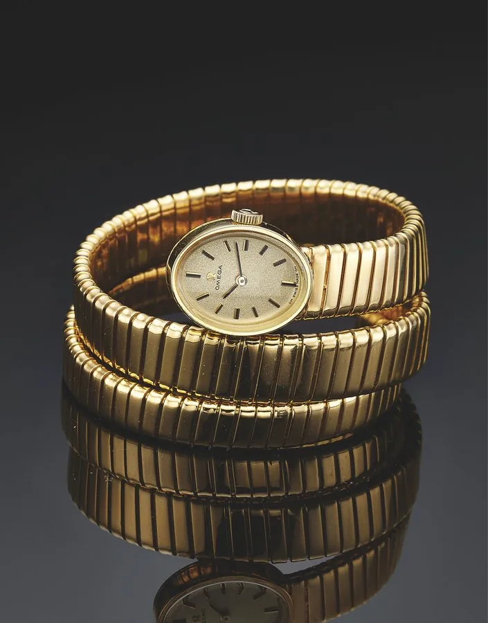 OMEGA SERPENTI YELLOW GOLD Omega, No. 28395596, Ref. 511-289. Very fine, rare and elegant, oval, 18K yellow gold wristwatch with an integral 18K yellow gold flexible Serpenti bracelet.