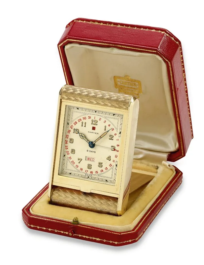 Travel Alarm Clock Cartier, Swiss, case No. 050445. Made circa 1940. Fine and extremely rare, rectangular, 9kt gold 8-day going travel timepiece with alarm, date and power reserve indication. Accompanied by its original Cartier fitted case. To be sold without reserve