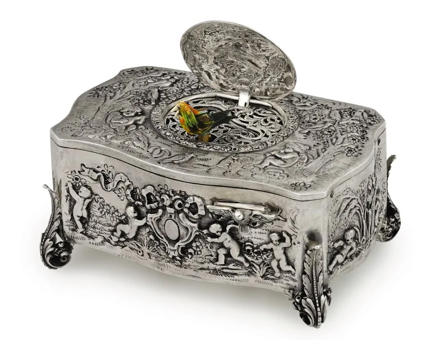 SILVER SINGING BIRD BOX Attributed to Griesbaum, Germany. Made circa 1950 in the style of the late 19th century. Fine, repoussé sterling silver singing bird box.