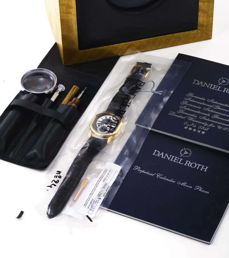 DANIEL ROTH YELLOW GOLD PERPETUAL CALENDAR Daniel Roth, "Perpetual Calendar", No 24. Made in the 1990's. Very fine and rare, double-ellipse shaped, self-winding, 18K yellow gold wristwatch with perpetual calendar, leap year indication, moon phases and an 18K yellow gold buckle. Accompanied by the original battery-operated winding box, instructions, blank certificate, and drawer with tool case including a magnifying glass and strap removing tools.