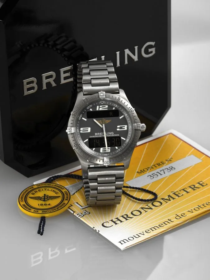 BREITLING REF. E75362 AEROSPACE TITANIUM QUARTZ Breitling, Genève, Aerospace, case No. 351738. Ref. E75362. Made in the 1990's. Fine, two-time zone, water-resistant, titanium, quartz wristwatch with timer chronograph to 1/100th seconds, alarm and a titanium link bracelet with deployant clasp. Accompanied by the original fitted box, chronometer certificate, warranty and instruction booklet. To be sold without reserve