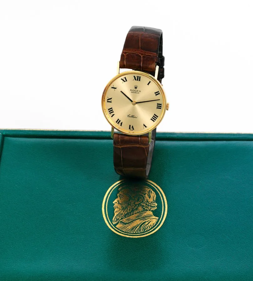 rolex Yellow Gold Cellini Rolex, Geneve, 'Cellini', case No. 4086197, Ref. 3833. Sold on August 2, 1977. Fine, thin, 18K yellow gold wristwatch with a yellow gold-plated Rolex buckle. Accompanied by fitted box, guarantee (now void) and booklet. To be sold without reserve