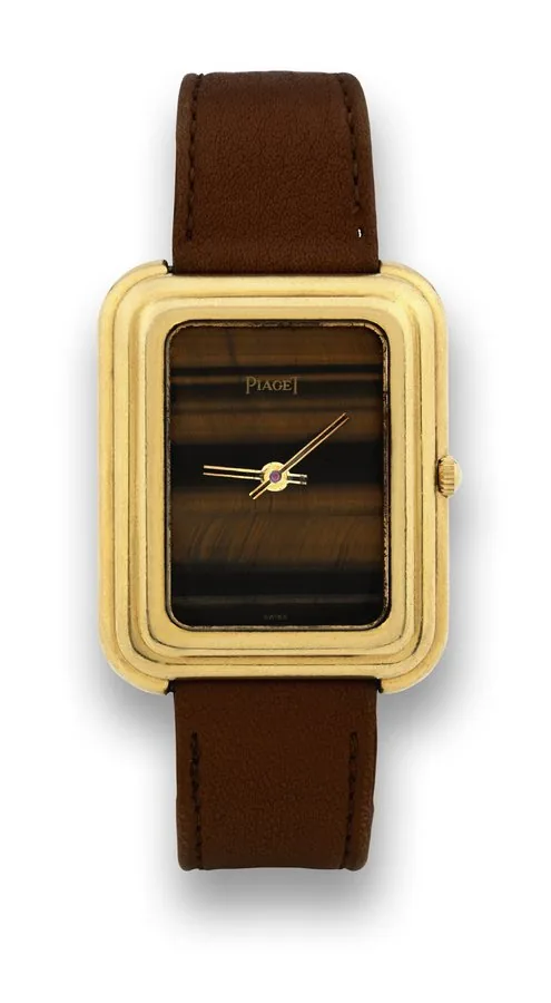 PIAGET, REF. 14101, YELLOW GOLD QUARTZ, TIGER EYE DIAL Piaget, case No. 205349, Ref. 14101. Made in the 1980's. Very fine and elegant, rectangular, 18K yellow gold quartz wristwatch with tiger eye dial and an 18K yellow gold Piaget buckle.