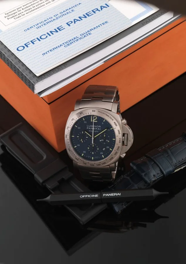 PANERAI REF. OP 6779 PAM 326 LUMINOR CHRONO DAYLIGHT TITANIUM Luminor Panerai, Firenze 1860, Daylight - Chronograph, Automatic, No. M 284 / 500, Ref. OP 6779. Made in a limited edition of 500 pieces in 2010. Fine, large, cushion-shaped, self-winding, water resistant, titanium and stainless steel wristwatch with round button chronograph, registers, tachometer, date and a stainless steel Panerai link bracelet with double deployant clasp. Accompanied by the original wooden box, guarantee, instructi