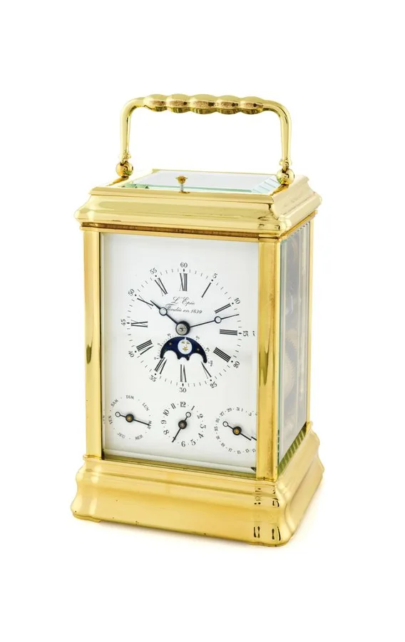 L'EPÉE - CARRIAGE CLOCK WITH CALENDAR & MOON PHASE L'Epée, France. Made in the late 20th century. Fine, gold-plated, 8-day going, hour and half-hour striking and repeating carriage clock with duo-date calendar, alarm, moon phases and lunar calendar. Accompanied by a key.