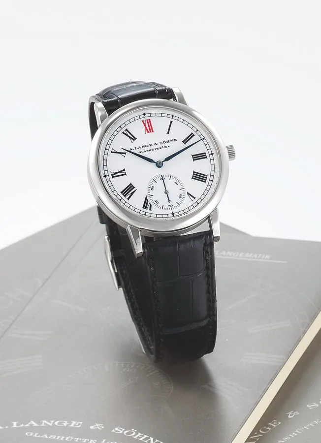 A. Lange & Söhne Ref. 302.025 Enamel Dial Anniversary Langematik A. Lange & Söhne, Glashütte i. Sa., 'Anniversary Langematik', No. 494/500, No. 22437, case No. 132494, Ref. 302.025. Made in a limited edition of 500 pieces to celebrate the new Millennium in 2000, sold on October 2nd, 2004. Very fine and rare, self-winding, water-resistant platinum wristwatch with enamel dial, zero-reset function, and a platinum A. Lange & Söhne buckle. Accompanied by fitted box, warranty and instruction booklet.