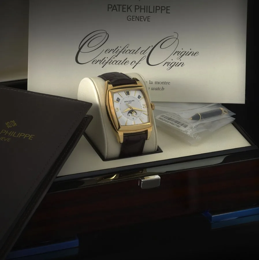 PATEK PHILIPPE REF. 5135 ANNUAL CALENDAR YELLOW GOLD Patek Philippe, Genève, Gondolo Calendario - Annual Calendar, No. 3652002, case No. 4441182, Ref. 5135J. Made in 2008, sold April 20th, 2009. Very fine, tonneau-shaped, Art Deco style, center seconds, self-winding, water-resistant, 18K yellow gold wristwatch with annual calendar, moon phases, 24-hour indication and an 18K yellow gold Patek Philippe buckle. Accompanied by the original fitted box, Certificate of Origin, booklets, pouch, plastic