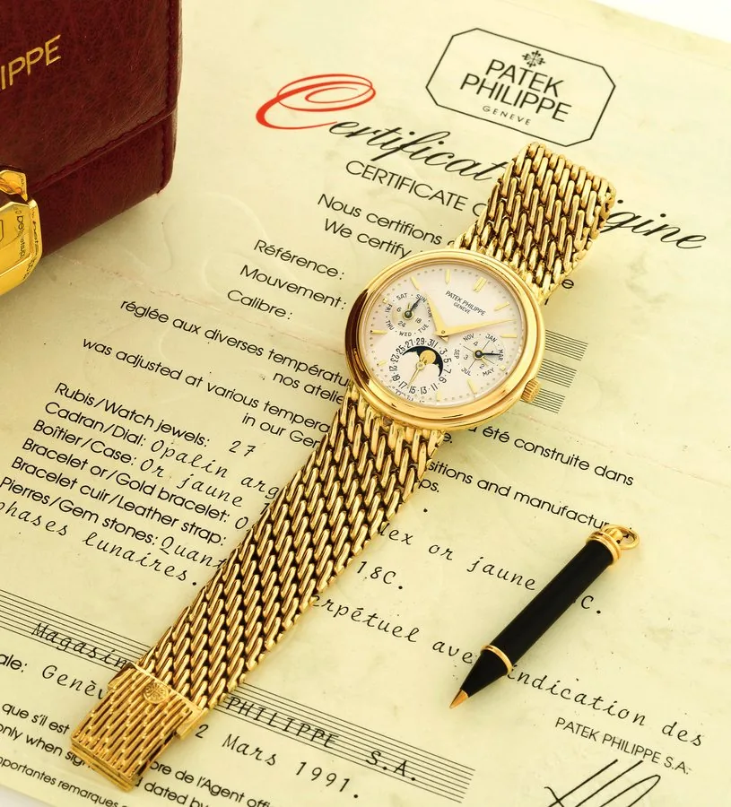 PATEK PHILIPPE REF 3945, PERPETUAL CALENDAR Patek Philippe, Genève, No. 772149, Ref. 3945/1. Sold on March 12th, 1991. Extremely fine and rare, self-winding, 18K yellow gold wristwatch with perpetual calendar, moon phases and an integral 18K yellow gold Patek Philippe mesh bracelet. Accompanied by the original Patek Philippe fitted box, certificate of origin, instruction manual, setting pin and extra winding box.