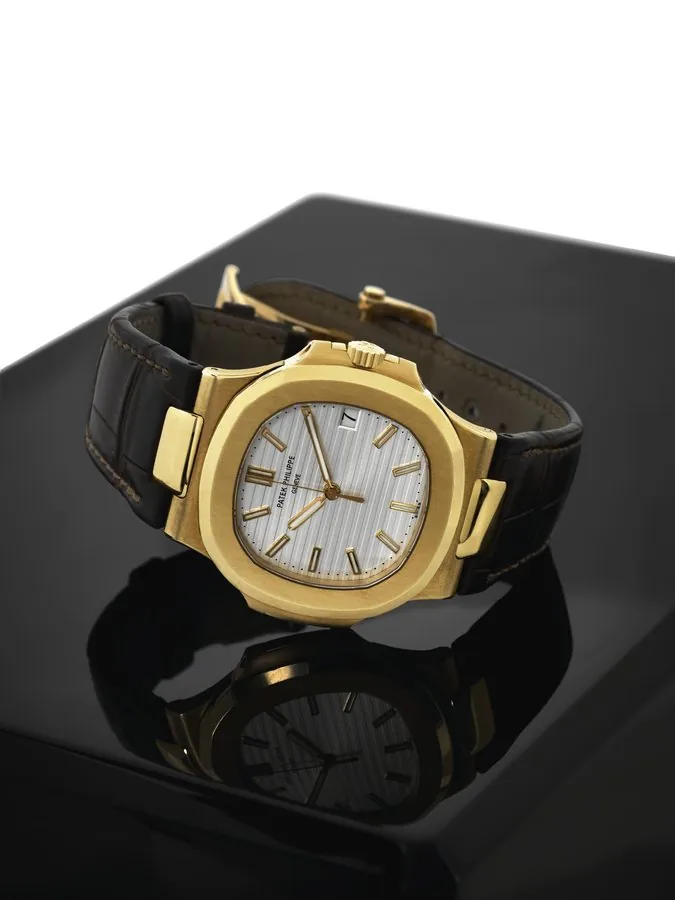 PATEK PHILIPPE REF. 5711 NAUTILUS Patek Philippe, Genève, Nautilus, No. 3620024, case No. 4430186, Ref. 5711J. Sold in September, 2007. Very fine, cushion-shaped, center seconds, self-winding, water-resistant 18K yellow gold wristwatch with date and an 18K yellow gold double deployant clasp. Accompanied by a fitted box, Certificate of Origin and booklets.