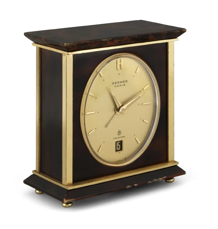 Hermès - Desk Clock Hermès, Paris, No. 1337, the movement by Luxor, Swiss. Made circa 1960. Fine, gilt-brass and painted 8-day going desk clock with alarm and calendar.