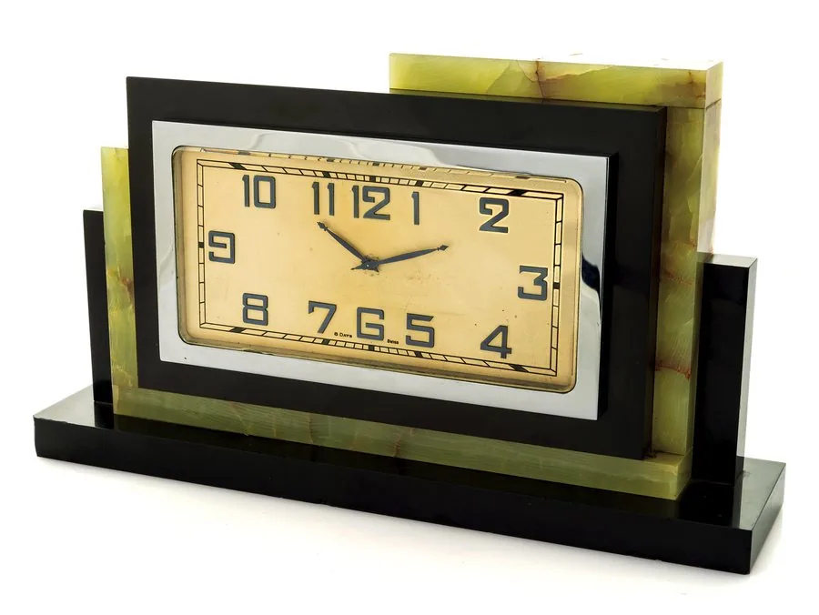 MARBLE & ONYX ART DECO CLOCK Swiss, "8-Days". Made circa 1925. Fine, 8-day going, asymmetric marble, onyx and chromed, Art Deco mantel clock.