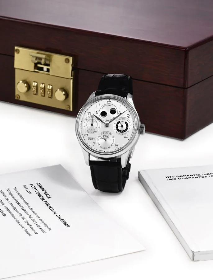 IWC PORTUGESE PERPETUAL CALENDAR PLATINUM LIMITED EDITION International Watch Co., Schaffhausen, "Portuguese - Perpetual Calendar", No. 165/250, case No. 2919178, Ref. 5021. Made in a limited edition of 250 pieces in 2002. Very fine and rare, large, self-winding, water-resistant, platinum wristwatch with secular perpetual calendar, moon phases, 7-day power-reserve indicator and a platinum IWC deployant clasp. Accompanied by the original numbered locking wooden box, guarantee, instruction booklet