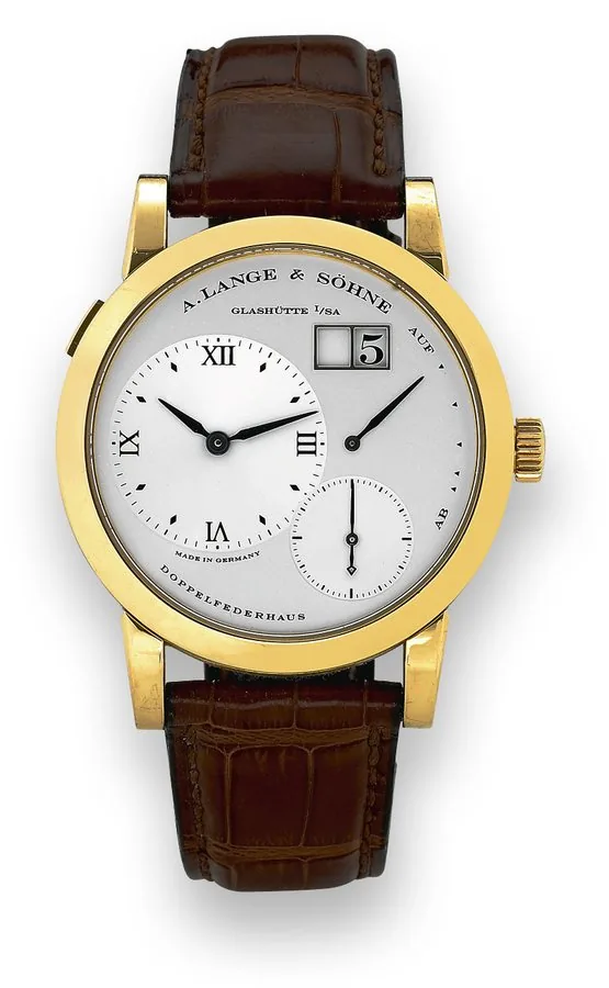 Lange 1 A. Lange & Söhne, Glashütte i. SA, Lange 1, Ref. 101.022. Made in 2001, sold in October 2002. Very fine, water-resistant, 18K yellow gold wristwatch with offcenter hour dial, large date, power-reserve and an 18K yellow gold A. Lange & Söhne buckle. Accompanied by the original box, guarantee, and instruction booklet.