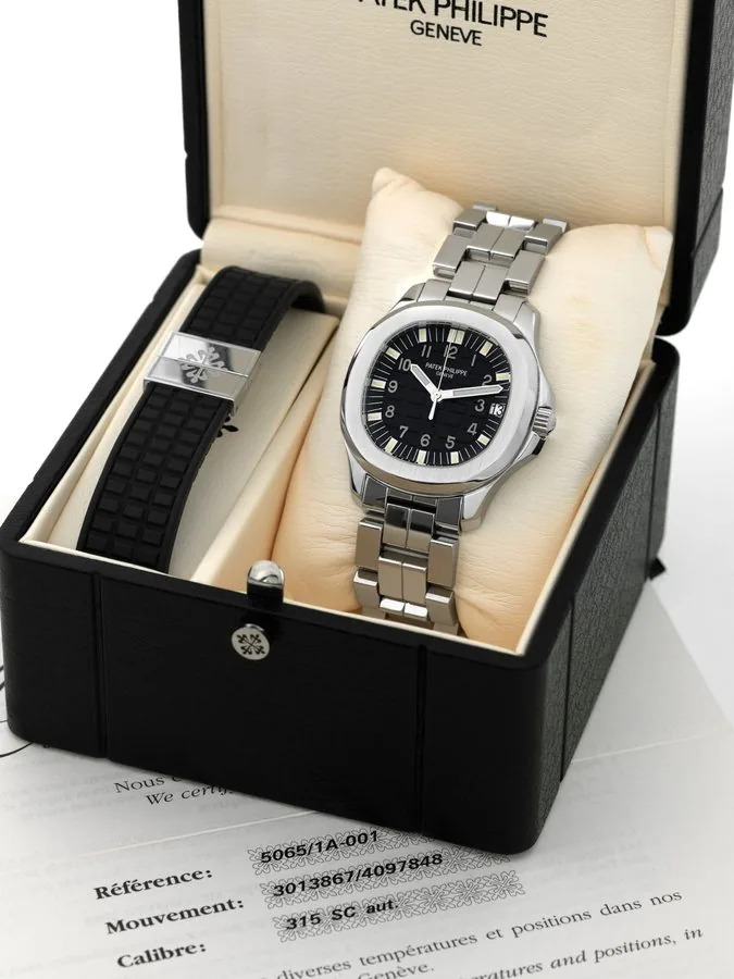 PATEK PHILIPPE, REF. 5065/1A, AQUANAUT Patek Philippe, Genève, "Aquanaut," No. 3013867, case No. 4097848, Ref. 5065/1A. Sold on July 18th, 2001. Fine, cushion-shaped, center-seconds, self-winding, water resistant, stainless steel wristwatch with date and a stainless steel Patek Philippe bracelet with double deployant clasp. Accompanied by the original fitted box, certificate, instruction booklet, overhaul invoice dated April 2007 and extra blue rubber Patek Philippe strap.