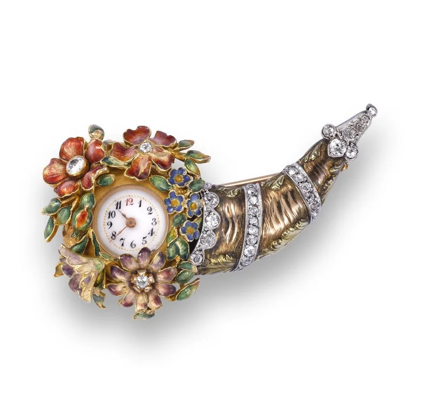 The cornucopia Swiss. Made circa 1910. Fine and unusual 18K gold, enamel and diamond keyless brooch watch in the form of a cornucopia.
