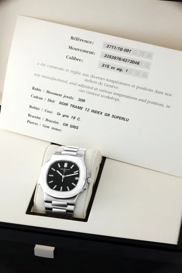 Patek Philippe White Gold, Ref. 3711/1G Nautilus Patek Philippe, Genève, 'Nautilus', movement No. 3253876, case No. 4273046, Ref. 3711/1G. Made in 2005, sold on October 1st, 2005. Very fine, water-resistant, self-winding, center seconds, 18K white gold wristwatch with date and an 18K white gold Patek Philippe bracelet with double deployant clasp. Accompanied by the original Patek Philippe fitted box, extra bracelet link, Certificate of Origin and booklets.
