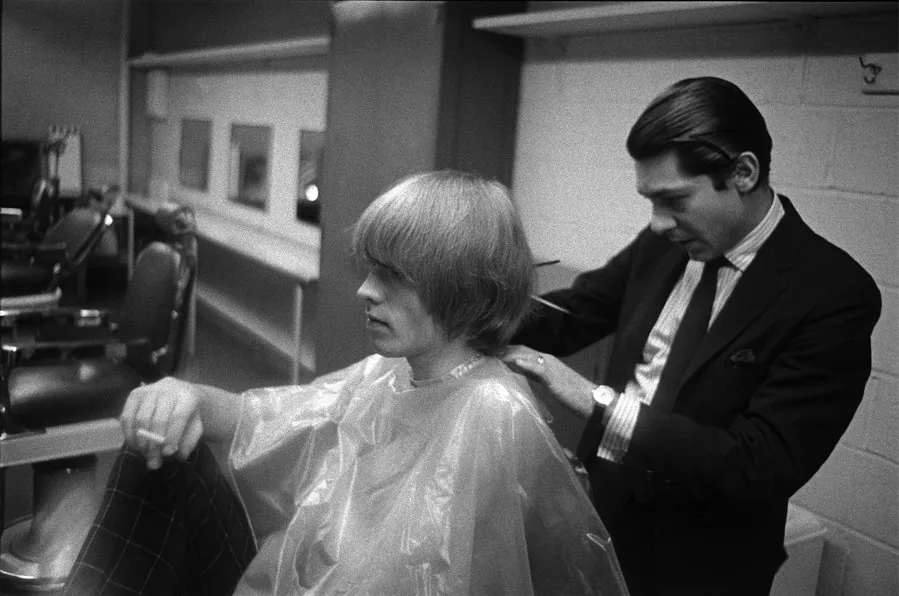 BRIAN JONES, NEW YORK CITY, 1965 Haircut, NBC TV studios LINER NOTES Brian was very vain about his hair and would have it trimmed at any opportunity; here by the stylist at the NBC make-up department. -Gered Mankowitz SPECIFICS Shot with a Nikon F, Kodak Tri-X film SIZE 16" x 20" MEDIUM Silver gelatin print. VALUE $2,000 - $2,700 STARTING BID $1,575