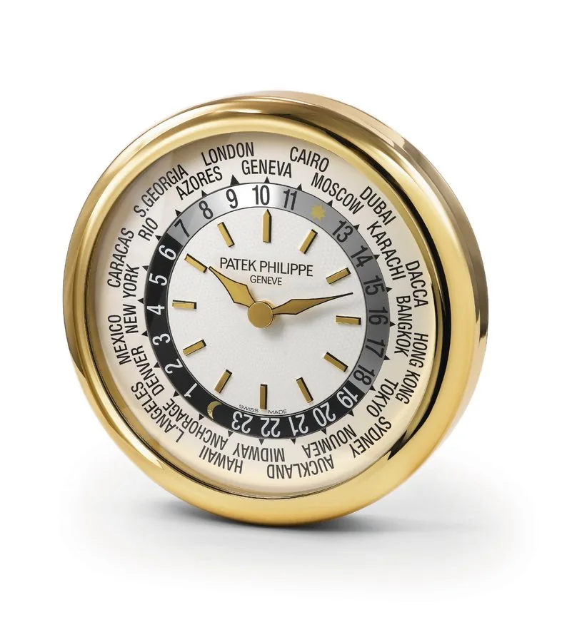 PATEK PHILIPPE LARGE WORLD-TIME WALL CLOCK Patek Philippe, Genève, made circa 2003. Fine and rare large gilt brass shop clock, modeled on the World Time Ref. 5110.