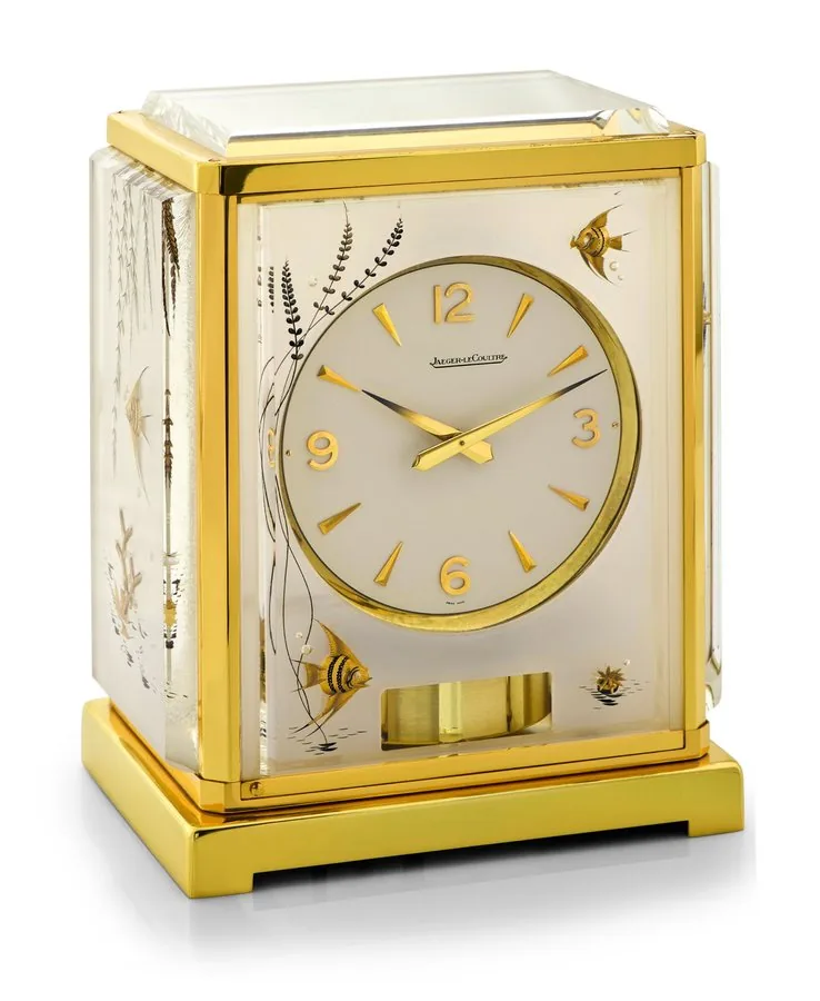 JAEGER-LECOULTRE WHITE AQUARIUM Jaeger-LeCoultre, Atmos. Made in the 1960s. Fine and very rare, rectangular gilt brass and perspex (lucite) mantel clock with aquarium panels and wound by barometric pressure changes. To be sold without reserve