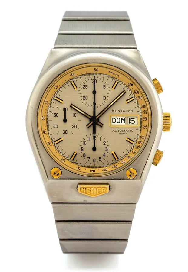 HEUER REF. 750.705 KENTUCKY AUTOMATIC CHRONOGRAPH DAY/DATE Heuer, Kentucky, Automatic, case No. 388965, Ref. 750.705. Made circa 1977. Fine, tonneau shaped, water resistant, self-winding, stainless steel and yellow gold wristwatch, round button chronograph, registers, day & date, tachometer and a stainless steel Heuer link bracelet with deployant clasp.