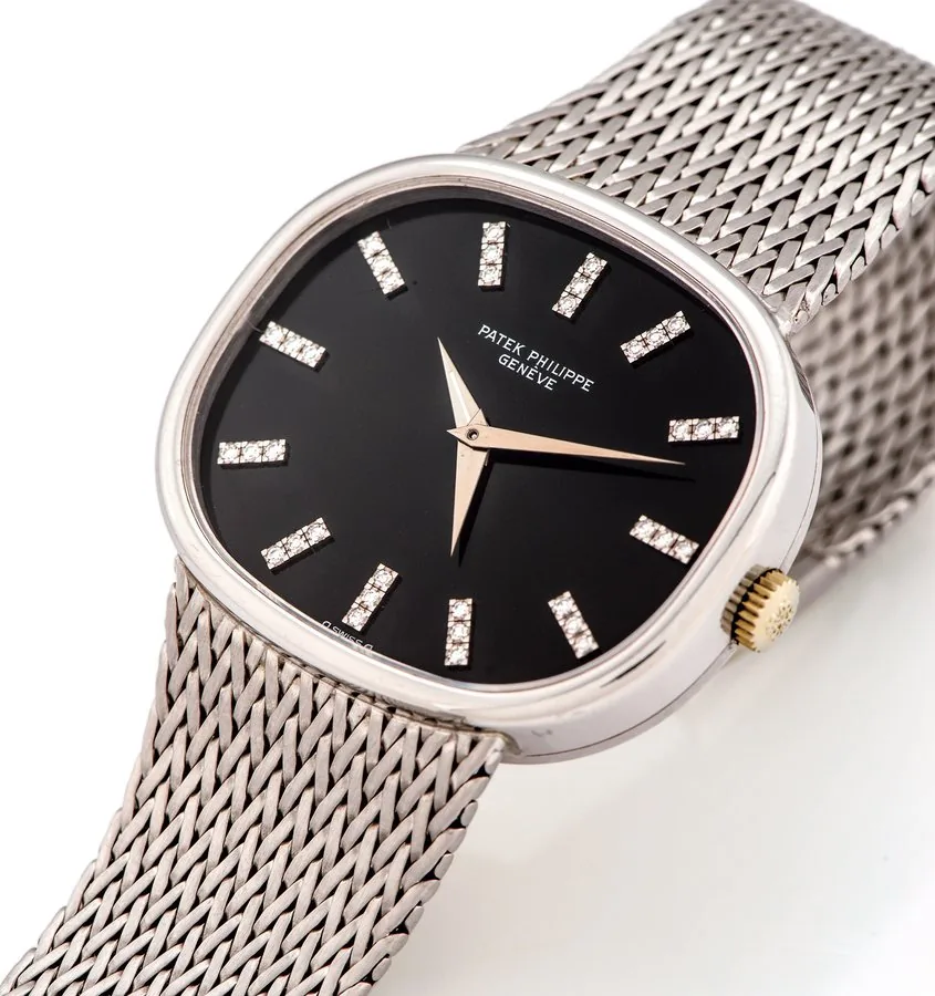 PATEK PHILIPPE REF 3619 TWO TIME ZONE DIAMOND INDEXES WHITE GOLD Patek Philippe, Genève, "Two Time Zone", No. 739768, case No. 2757187, Ref. 3619/1. Made circa 1980. Very fine and rare, large, horizontal oval, 18K white gold wristwatch with two time zones and three hands with an integrated Patek Philippe 18K white gold mesh bracelet. Accompanied by the Extract from the Archives.