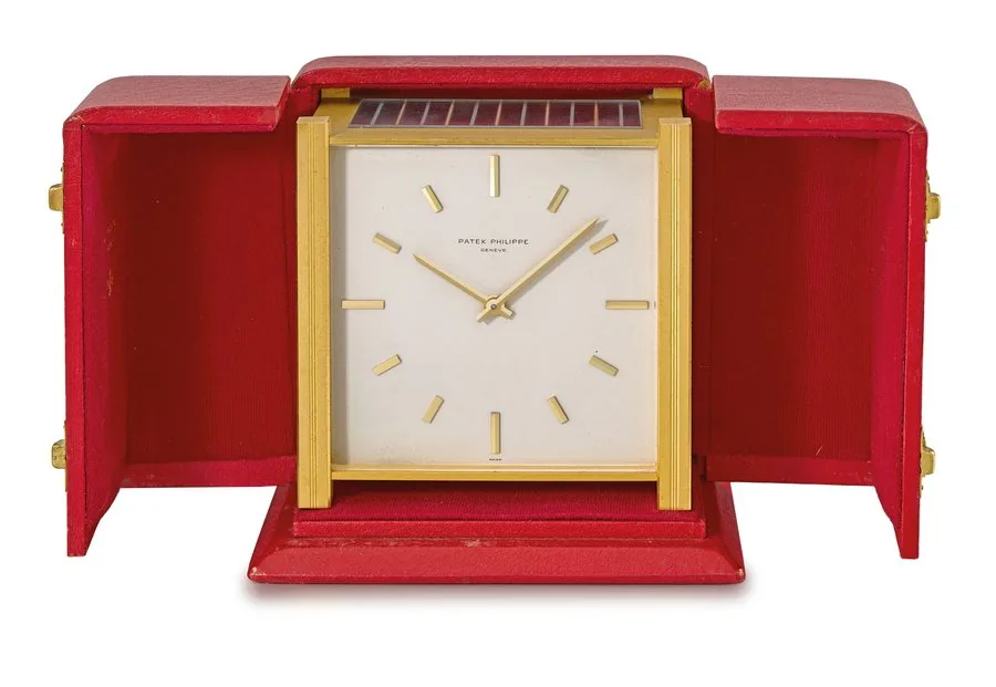 Patek Philippe. A gilt brass square-shaped solar-powered table clock with box Signed Patek Philippe, Genève, ref. 928, movement no. 873'484, case no. 1'054, manufactured in 1964