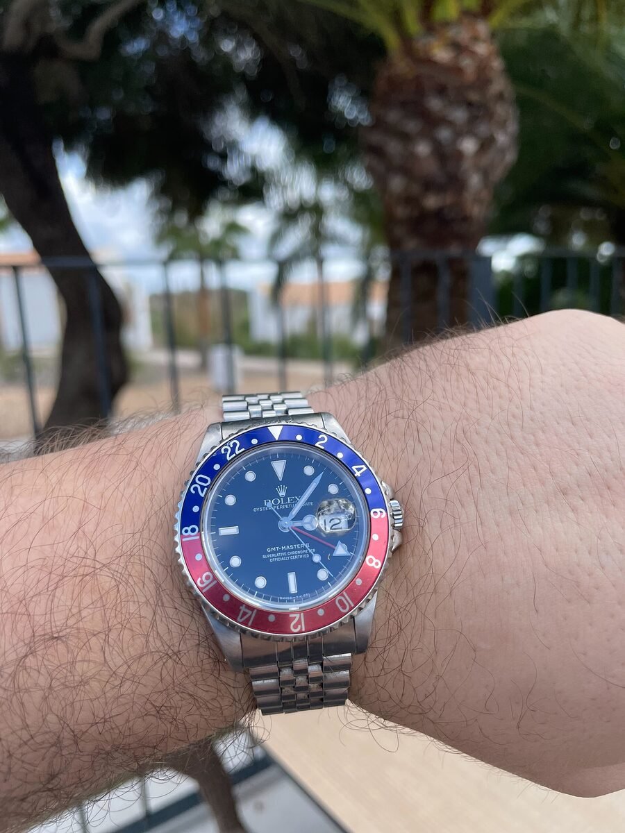A GMT-Master worn on the wrist showing its two-colour bezel
