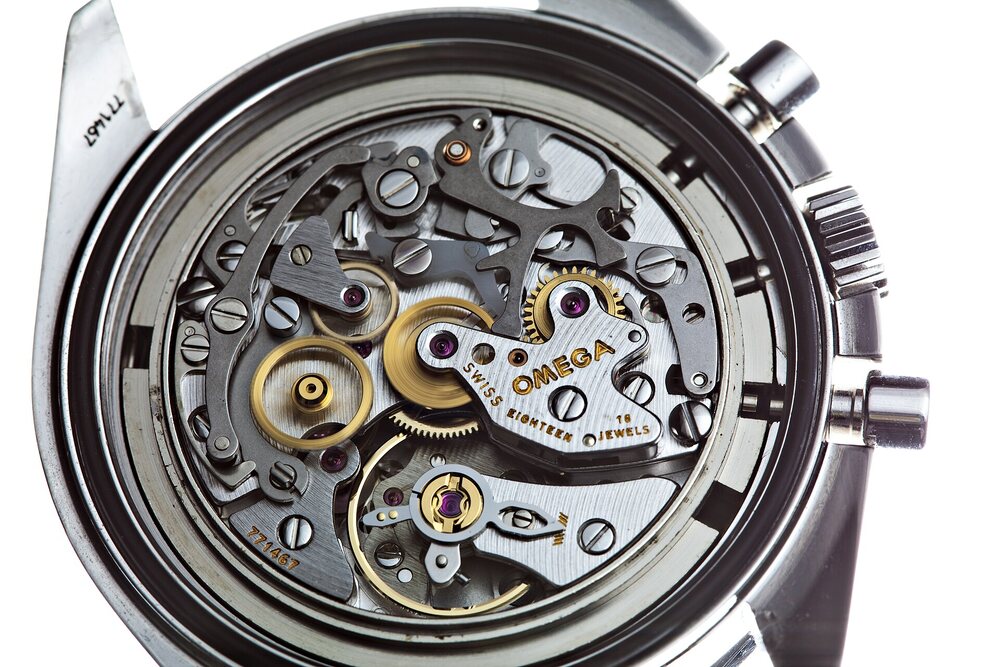 An exposed manual-wind chronograph movement seen through the caseback