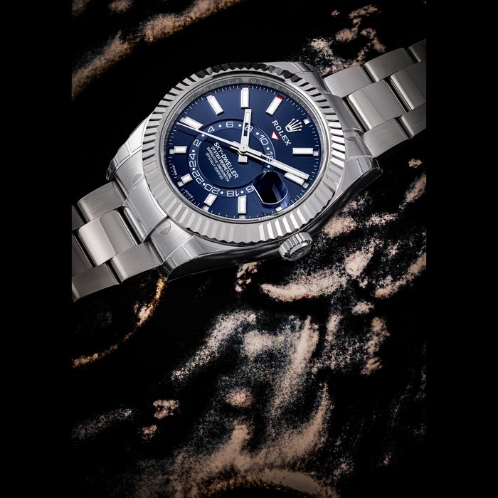 ROLEX. A STAINLESS STEEL AND WHITE GOLD ANNUAL CALENDAR AUTOMATIC WRISTWATCH WITH SWEEP CENTRE SECONDS, DUAL TIME, BRACELET AND BLUE DIAL SKY-DWELLER MODEL, REF. 326934, CASE NO. QW901996, CIRCA 2018