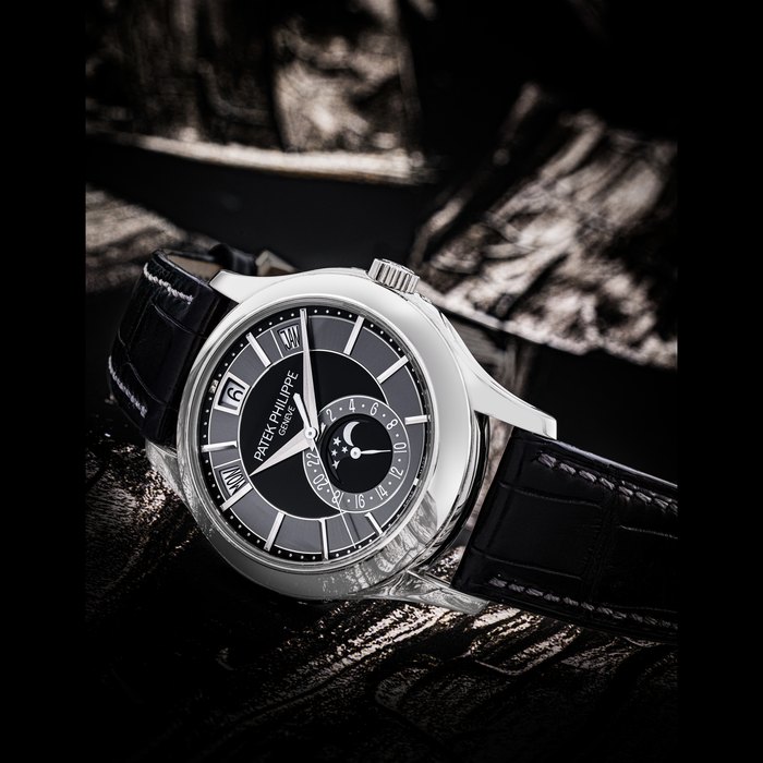 PATEK PHILIPPE. AN 18K WHITE GOLD AUTOMATIC ANNUAL CALENDAR WRISTWATCH WITH SWEEP CENTRE SECONDS, MOON PHASES AND 24 HOUR INDICATION REF. 5205G-010, MOVEMENT NO. 5’602’158, CASE NO. 4’538’750, CIRCA 2011
