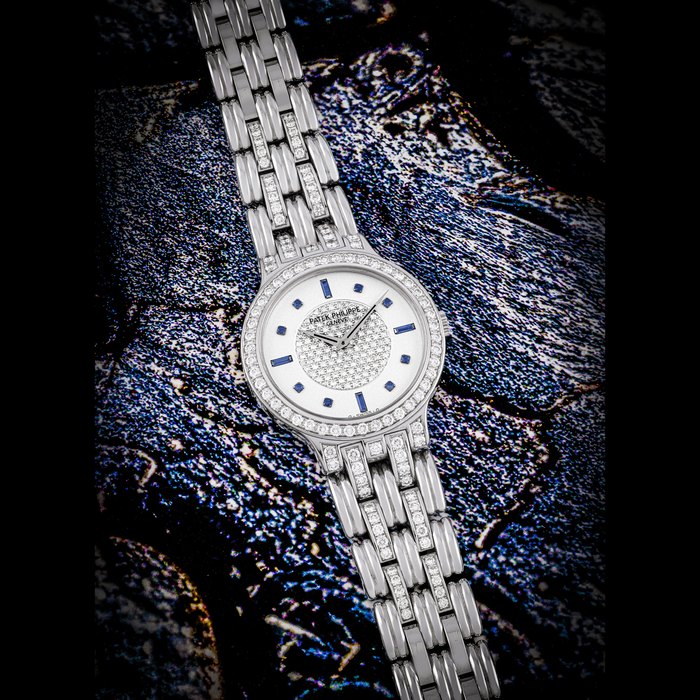 PATEK PHILIPPE. AN 18K WHITE GOLD, DIAMOND AND SAPPHIRE-SET WRISTWATCH WITH BRACELET REF. 3963⁄3, MOVEMENT NO. 1’823’831, CASE NO. 2’915’271, CIRCA 1992