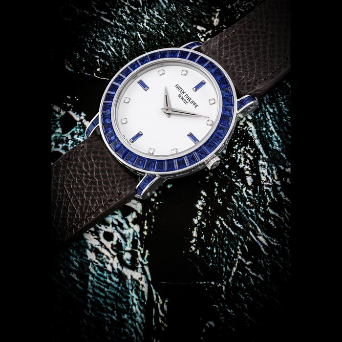 Patek Philippe PATEK PHILIPPE. AN 18K WHITE GOLD, DIAMOND AND BAGUETTE-CUT SAPPHIRE-SET AUTOMATIC WRISTWATCH REF. 5018⁄1, MOVEMENT NO. 1’200’483, CASE NO. 4’020’799, CIRCA 1997, Price & Market Data