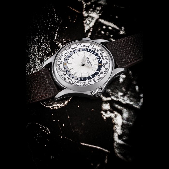 PATEK PHILIPPE. AN 18K WHITE GOLD AUTOMATIC WORLD TIME WRISTWATCH REF. 5110G-001, MOVEMENT NO. 3’213’957, CASE NO. 4’263’889, CIRCA 2004