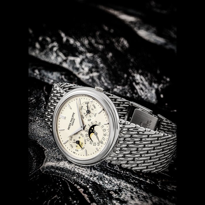 PATEK PHILIPPE. AN 18K WHITE GOLD AUTOMATIC PERPETUAL CALENDAR BRACELET WATCH WITH MOON PHASES, 24 HOUR AND LEAP YEAR INDICATION REF. 3945/001G, MOVEMENT NO. 774’358, CASE NO. 2’905’447, CIRCA 1993
