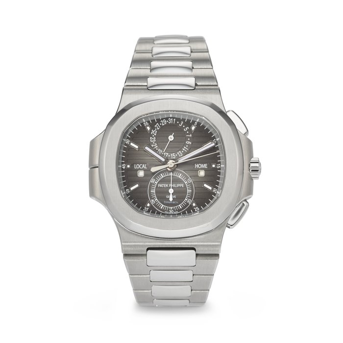 PATEK PHILIPPE. A VERY RARE AND LARGE STAINLESS STEEL AUTOMATIC FLYBACK CHRONOGRAPH DUAL TIME WRISTWATCH WITH DAY/NIGHT INDICATORS, DATE AND BRACELET SIGNED PATEK PHILIPPE, RETAILED BY TIFFANY & CO., NAUTILUS TRAVEL TIME MODEL, REF. 5990/1A-001, MOVEMENT NO. 7'097'302, CASE NO. 6'207'988, CIRCA 2018